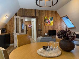 a dining room with a table with a vase on it at Schaapskooi 20 in Dwingeloo