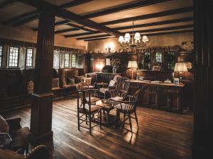 a living room with a table and chairs at Holdsworth House Hotel in Halifax
