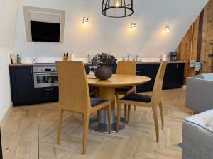 a kitchen with a wooden table and chairs at Schaapskooi 20 in Dwingeloo