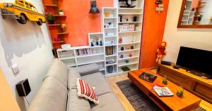 a living room with a couch and a tv at Duplex moderne au Palais des Papes in Avignon