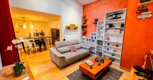 a living room with a couch and a table at Duplex moderne au Palais des Papes in Avignon +17 photos