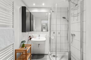a white bathroom with a sink and a shower at ParkVilla Puschendorf, 24-7 Self-Check-in in Puschendorf +19 photos