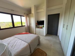 a bedroom with a bed and a flat screen tv at Brisas Vista Serena in Nueva Gorgona +11 photos