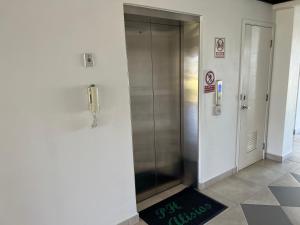 a elevator in a building with a sign on the floor at Brisas Vista Serena in Nueva Gorgona