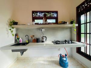a kitchen with a sink and a stove at Diddi's in Weligama +26 photos