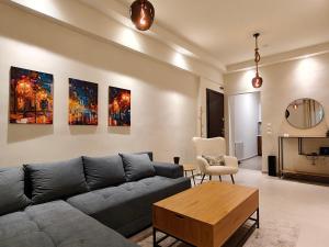 a living room with a couch and a table at Your Inn in Tríkala