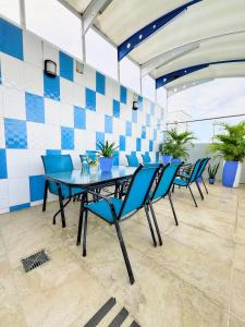a dining room with blue chairs and a table at Hotel la Ciudad in Barrancabermeja