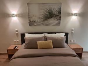 a bedroom with a large bed with two lights at Your Inn in Tríkala