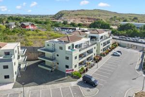an aerial view of a building with a parking lot at Penthouse Casa James, Mambo Beach, Jacuzzi & Sea View in Willemstad