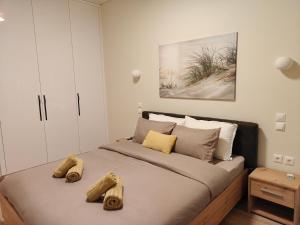 a bedroom with a large bed with two towels on it at Your Inn in Tríkala +18 photos