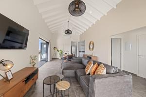 a living room with a couch and a table at Penthouse Casa James, Mambo Beach, Jacuzzi & Sea View in Willemstad