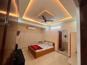a bedroom with a bed and a ceiling at HARI STAYs in Tirupati