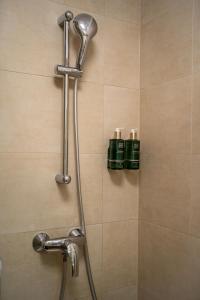 a shower with two green bottles in a bathroom at Cliché Luxury Apartment in Braşov +32 photos