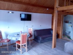 a living room with a table and a couch at Seeperle am Concordia See in Friedrichsaue