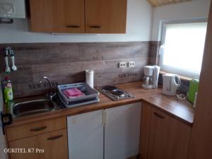 a kitchen with a sink and a counter top at Seeperle am Concordia See in Friedrichsaue