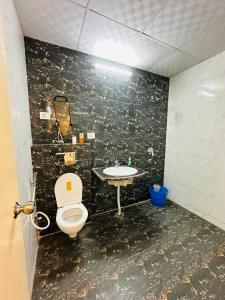 a bathroom with a toilet and a sink at Dream heaven in Greater Noida +23 photos