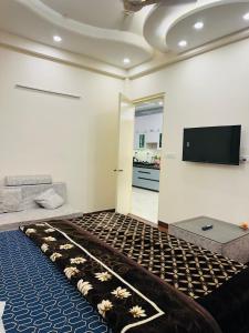 a living room with a flat screen tv on the wall at Dream heaven in Greater Noida