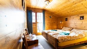 a bedroom with two beds in a wooden cabin at Haus Chämihitta, Riederalp Moosfluh in Riederalp