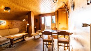 a living room with a table and chairs and a couch at Haus Chämihitta, Riederalp Moosfluh in Riederalp