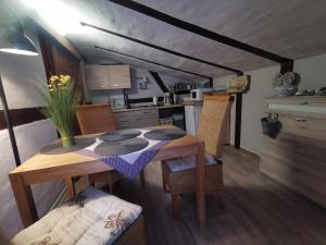 a kitchen with a wooden table with chairs and a tableablish at Tweet Tohuus in Feldberg