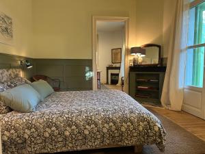 a bedroom with a bed and a window at Les Mimosas in Arcachon