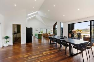 a dining room and living room with a table and chairs at The Barn Bonnie Doon in Bonnie Doon