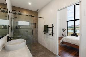 a bathroom with a tub and a bed and a shower at The Barn Bonnie Doon in Bonnie Doon +33 photos