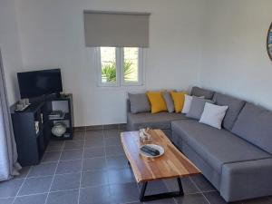 a living room with a couch and a coffee table at Romantic House Sea View Adults only in Ios Chora
