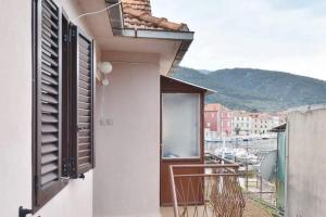 a balcony of a building with a view of a harbor at Three bedded room with an outdoor kitchen in Stari Grad