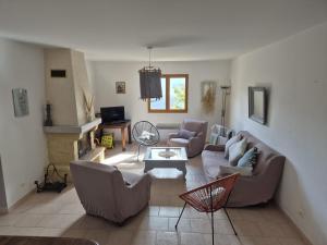 a living room with a couch and chairs and a table at MAISON TUCCARELLU in Letia