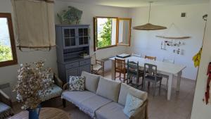 a living room with a couch and a table at MAISON TUCCARELLU in Letia