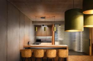 a kitchen with a counter with stools in it at Tatry Premium Apartment - PRIVATE Parking in Kežmarok