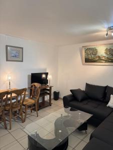 a living room with a couch and a table at Apparemment 2 pièces in Vaulx-en-Velin