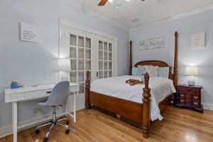 a bedroom with a bed and a desk and a computer at Honeymoon Suite with Shared POOL in Bay Saint Louis