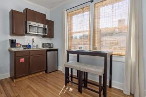 a small kitchen with a table and a microwave at Honeymoon Suite with Shared POOL in Bay Saint Louis +10 photos