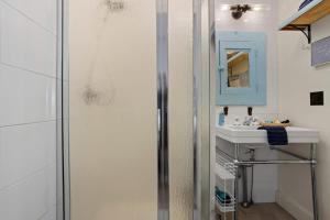 a bathroom with a sink and a shower at Honeymoon Suite with Shared POOL in Bay Saint Louis