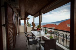 a balcony with a table and chairs and a view at Villa Amalia Sun Beach in Nea Vrasna