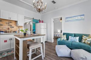 a kitchen and living room with a table and a couch at Suite Flamingo Pointe with Shared POOL in Bay Saint Louis