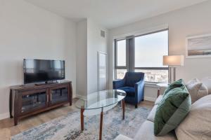 a living room with a couch and a tv at Private Apt Downtown in Quincy