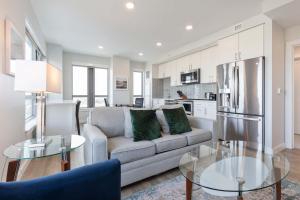 a living room with a couch and a refrigerator at Private Apt Downtown in Quincy