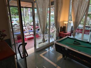 a room with a pool table and a balcony at Hotel Picador in Rimini
