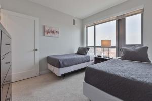 a bedroom with two beds and a window at Spacious Apt Downtown in Quincy +10 photos