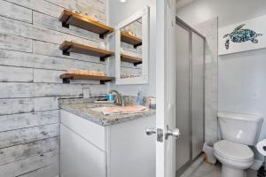 a bathroom with a sink and a toilet at Suite - Knome Dome with Shared Pool in Bay Saint Louis