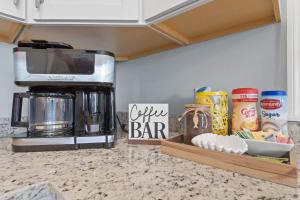a kitchen counter with a coffeemaker and a coffee bar at Suite - Knome Dome with Shared Pool in Bay Saint Louis