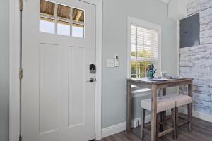 a door leading into a dining room with a table and stool at Suite - Knome Dome with Shared Pool in Bay Saint Louis