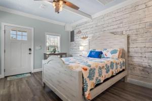 a bedroom with a bed and a brick wall at Suite - Knome Dome with Shared Pool in Bay Saint Louis +11 photos