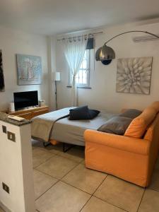 a bedroom with a bed and a couch at Grace 101 in Vigevano