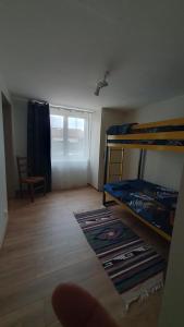 a room with two bunk beds and a window at le pied des monts in Sainte-Consorce