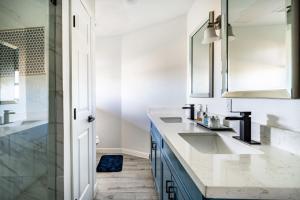 a bathroom with two sinks and a shower at 6 Bedroom, 3 unit Triplex in Crystal Beach in Port Bolivar +77 photos