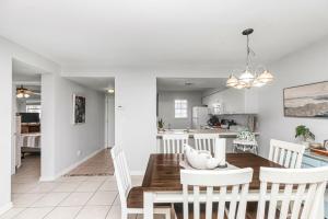a dining room and kitchen with a table and chairs at Islandwood in Fort Walton Beach